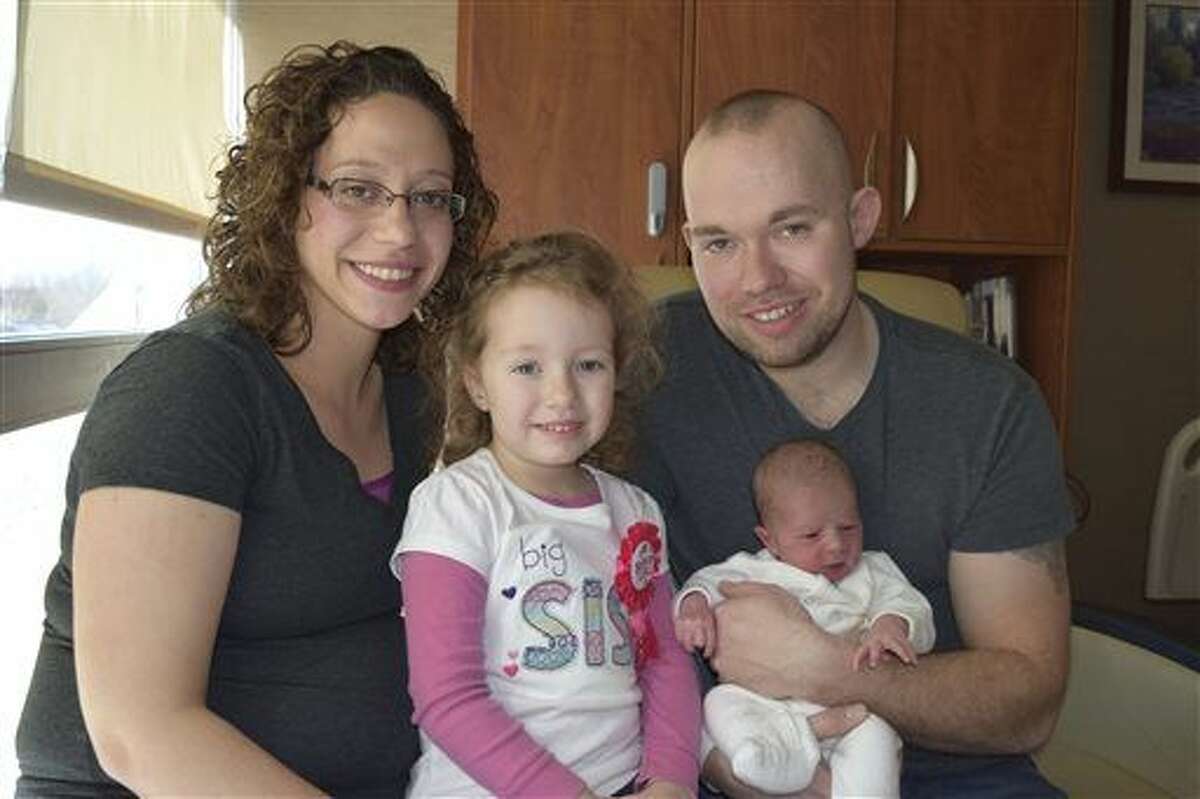 In this Monday, Feb. 29, 2016 photo provided by Henry Ford Health System, Chad and Melissa Croff pose with their their newborn Evelyn Joy and Eliana Adaya, center left, at Henry Ford Macomb Hospital in Clinton Township, Mich. Evelyn Joy was born, Monday, a Leap Day, as was her sister, Eliana Adaya, also a Leap Day baby, born Feb. 29, 2012.