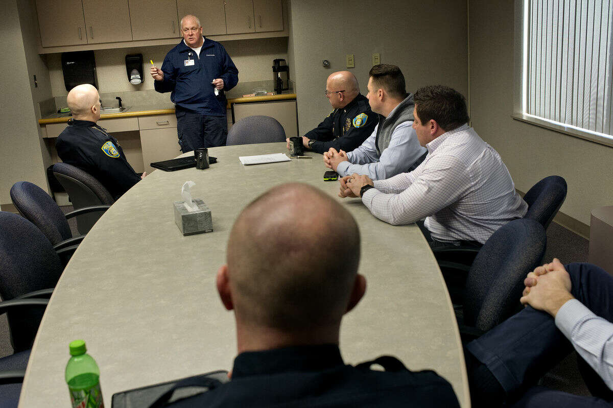 MidMichigan Medical Center-Midland paramedic Jay Anderson, center, gives Midland Police officers training on using naloxone hydrochloride at the Midland Law Enforcement Center.