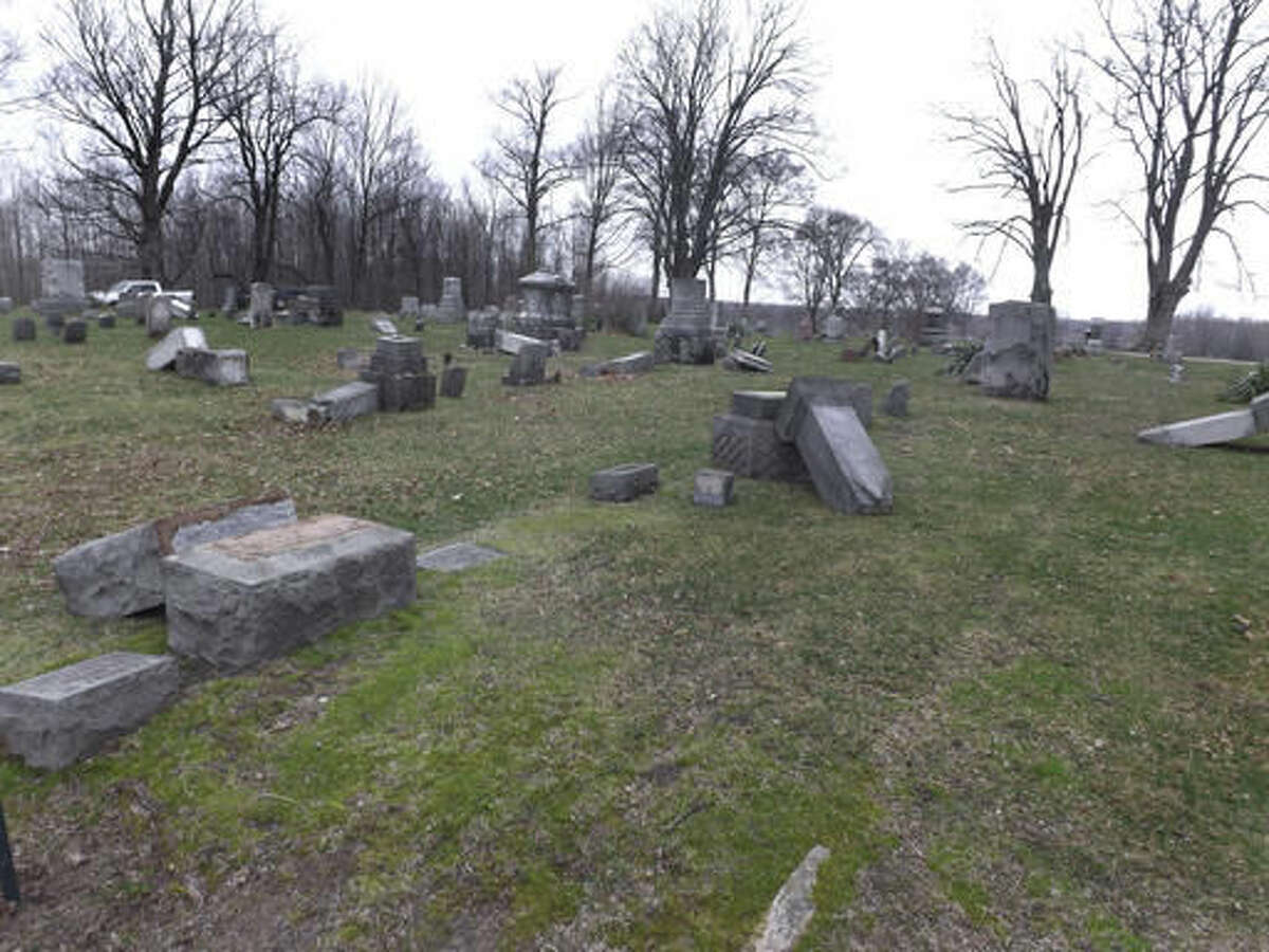 This photo provided by the Van Buren County Sheriff's Office shows some of the more than 30 headstones found tipped over or damaged at Lacota Cemetery in Geneva Township, Mich. The Van Buren County Sheriff's Department says Wednesday, March 23, 2016, the vandalism at Lacota Cemetery in Geneva Township may have happened Saturday evening. (Van Buren County Sheriff's Office via AP)