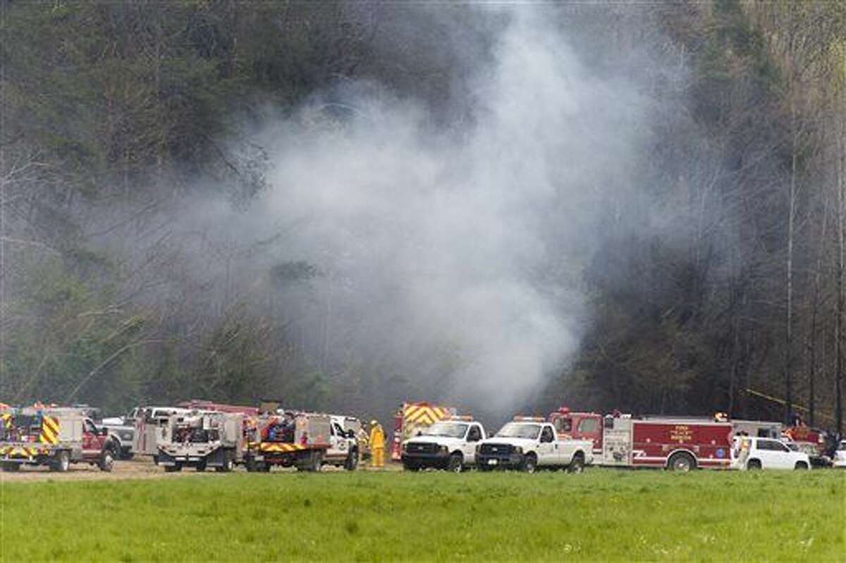 Emergency vehicles respond to the scene of a fatal helicopter crash, Monday, April 4, 2016, in Pigeon Forge, Tenn. A sightseeing helicopter crashed near the Great Smoky Mountains National Park in eastern Tennessee, officials said. (Saul Young/Knoxville News Sentinel via AP) MANDATORY CREDIT