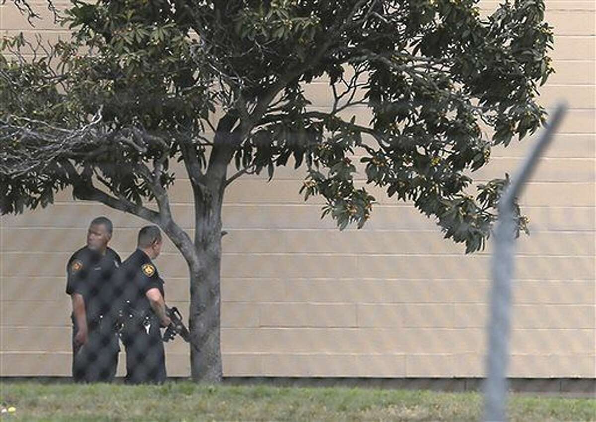 Two Bexar County Sheriff's Deputies stand outside a building near the scene of a shooting at Joint Base San Antonio-Lackland, Friday, April 8, 2016, in San Antonio. (John Davenport/The San Antonio Express-News via AP) RUMBO DE SAN ANTONIO OUT; NO SALES; MANDATORY CREDIT