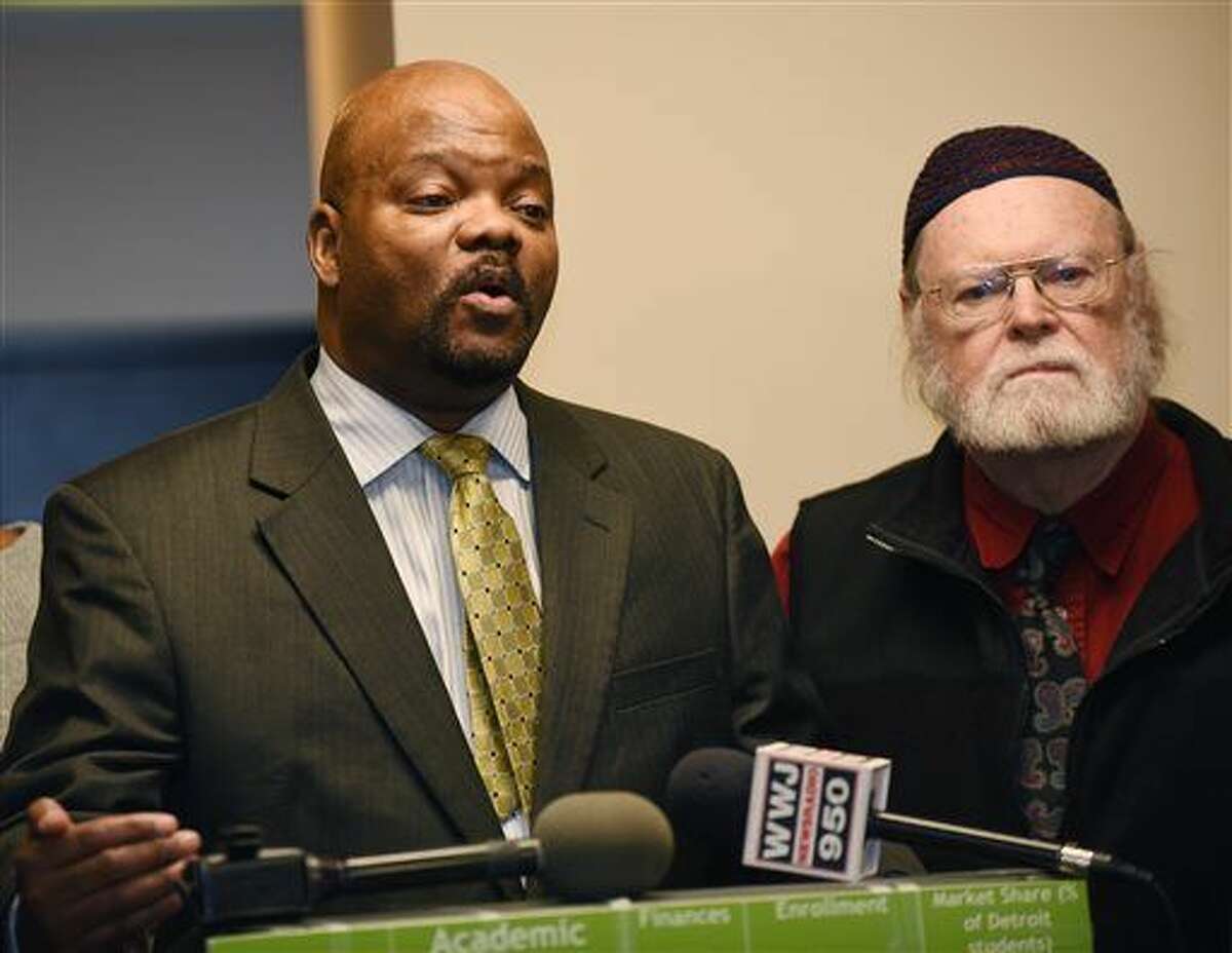 LaMar Lemmons, school board member, gives his remarks during a press conference as Dr. John Telford, right listens, Thursday, April 7, 2015, in Detroit. Members of the Detroit school board announced a lawsuit against Gov. Rick Snyder over poor financial, building and other conditions in Detroit Public Schools.