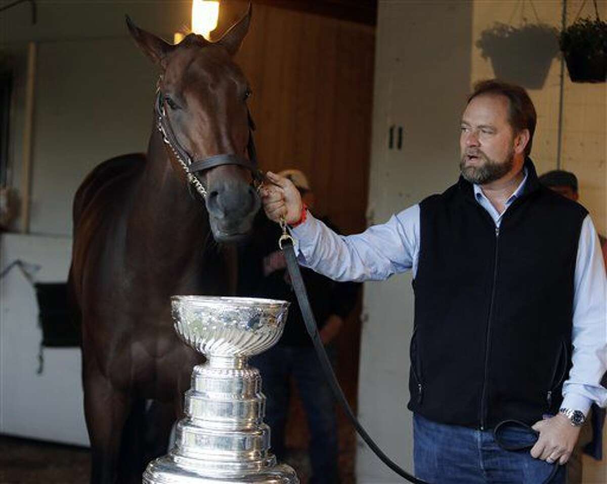 Kentucky Derby entrant Nyquist and trainer Doug O'Neill pose with the Stanley Cup before the 142nd running of the Kentucky Derby horse race at Churchill Downs Saturday, May 7, 2016, in Louisville, Ky. (AP Photo/Garry Jones)