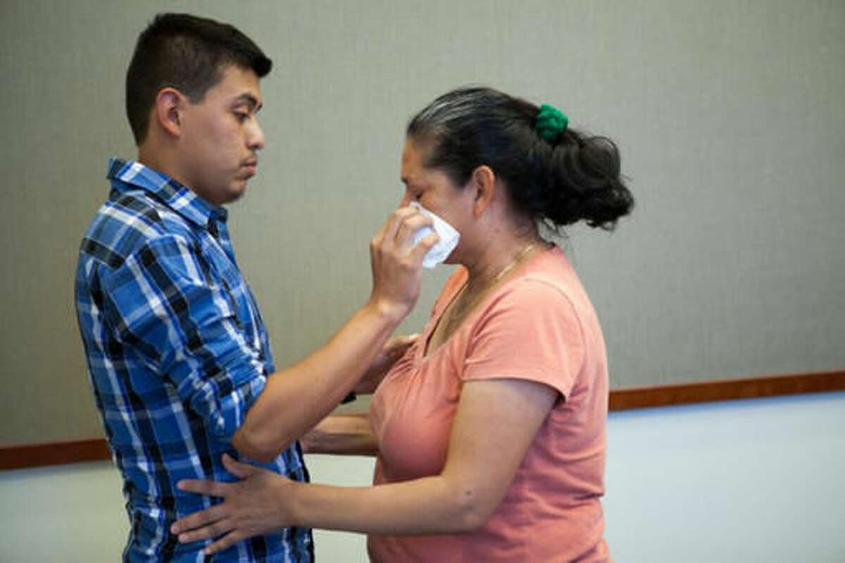 Steve Hernandez wipes a tear from his mother's eye after seeing her for the first time in 20 years in San Diego, Calif., on Thursday, June 9, 2016. Steve Hernandez was abducted by his father Valentin Hernandez from their Rancho Cucamonga residence in 1995 when he was 18-months-old. Since that time, 42-year-old Maria Mancia had searched for her son to no avail. The boy, Steve Hernandez, now a man of about 22, has been found in Mexico. On Thursday he was brought to the U.S. to meet his mother.Authorities interviewed the boy and took a DNA swab. The facts of his life, and the DNA, matched. (Christopher Lee/San Bernardino County District Attorney's Office via AP)