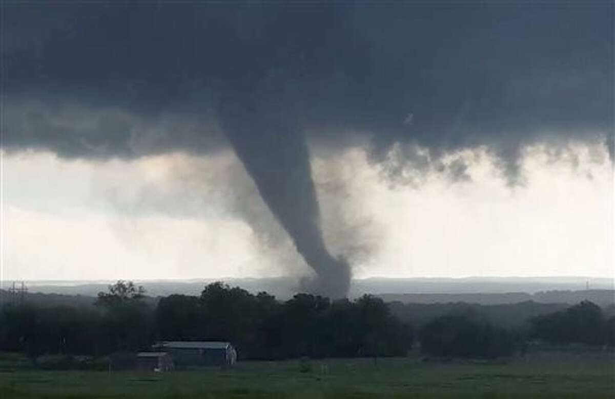 This image made from a video taken through a car window shows a tornado near Wynnewood, Okla., Monday, May 9, 2016. A broad tornado capable of leaving "catastrophic" damage in its wake churned across the Oklahoma landscape Monday, prompting forecasters to declare a tornado emergency for two communities directly in its path. (Hayden Mahan via AP) MANDATORY CREDIT