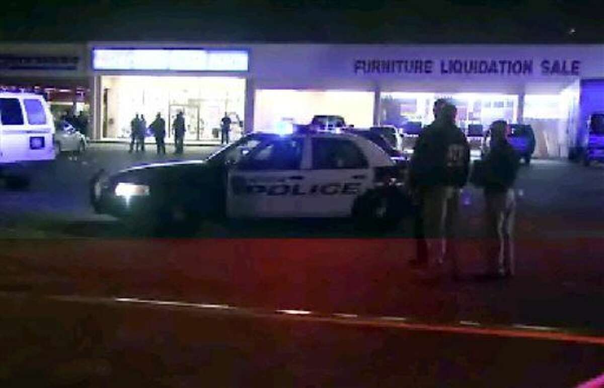 This still image taken from video provided by KPRC shows police responding to the scene of a shooting Thursday in Houston. Police fired at the suspected robbers Thursday night outside the furniture store, killing two and injuring two other members of the group, which was being monitored by a tactical team investigating other robberies earlier in the day.