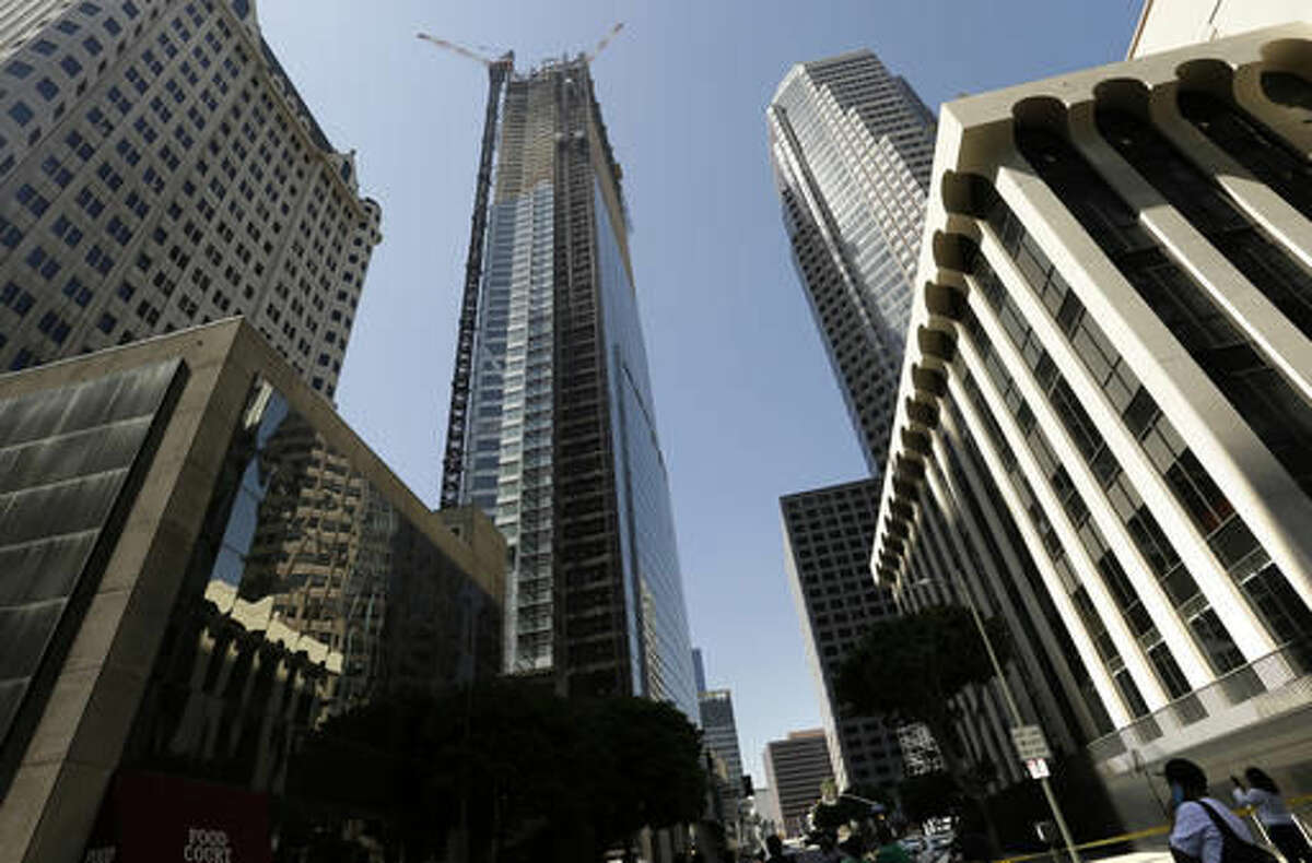 Passerby's look up at the Wilshire Grand Tower on South Figueroa Street where a worker fell to his death on Thursday.