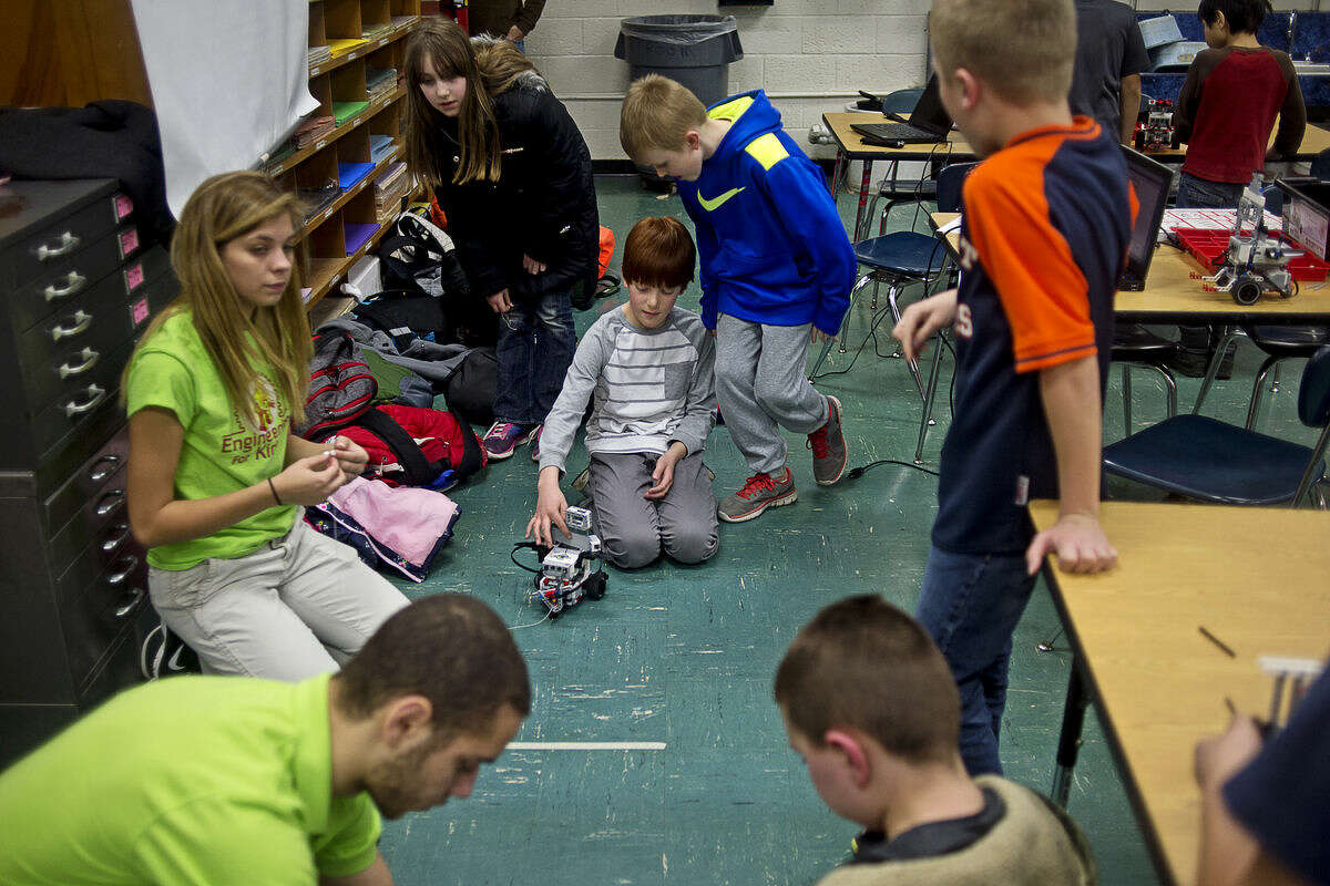 Plymouth fourth-graders Trevor Hallberg, 10, center left, and Braiden Katzinger, 10, center right, get ready to test their robot in a game of tug-of-war at Plymouth Elementary School on Tuesday. Engineering for Kids, which offers after-school and birthday party programs focused on STEM activities, will be opening a Learning Center at 324 S. Saginaw Road. There will be an open house Saturday from 3 p.m. to 8 p.m.