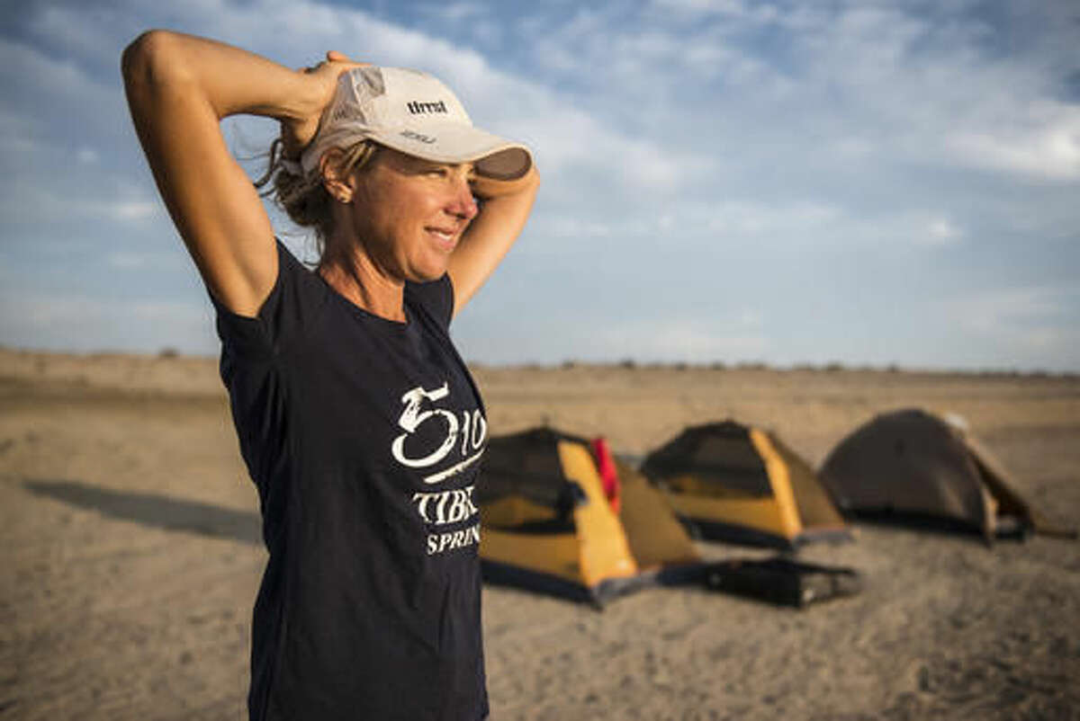 In this March 16, 2016, photo provided by Kelvin Trautman, Australian long-distance runner Mina Guli, the founder and CEO of Thirst, participates in the 7 Deserts Run4Water expedition in Atacamba, Chile, while attempting to run through seven deserts on seven continents in seven weeks to raise awareness of worldwide water shortages, and she is almost done with the more-than-thousand-mile run. (Kelvin Trautman via AP)
