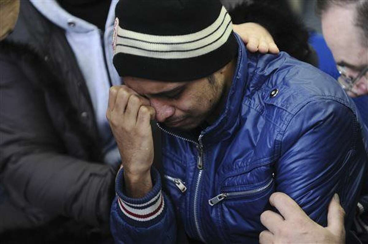 A relative of the plane crash victim sobs as he is comforted by other relatives at the Rostov-on-Don airport, about 950 kilometers (600 miles) south of Moscow, Russia Saturday, March 19, 2016. An airliner from Dubai crashed early Saturday while landing in the southern Russian city of Rostov-on-Don in strong winds, Russian officials said. (AP Photo)