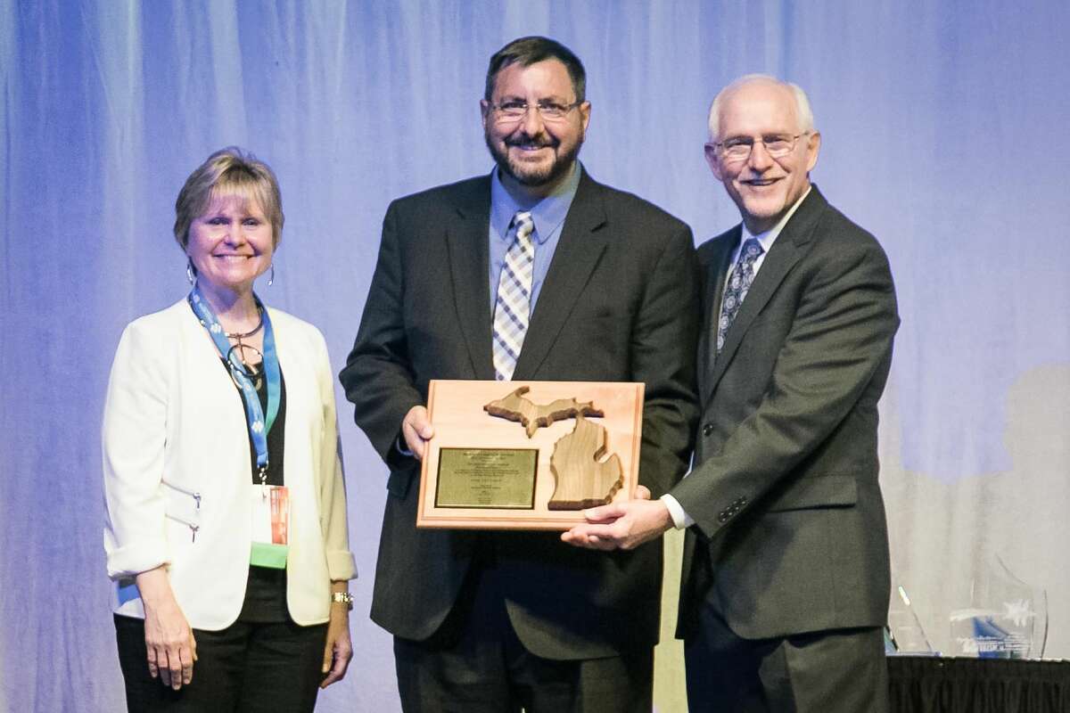 Sen. Jim Stamas, R-Midland, receives the 2016 Senator of the Year Award from the Michigan Lodging and Tourism Association on April 18. Incoming MLTA President and CEO Diana Richeson, left, and retiring MLTA President and CEO Steve Yencich, right, presented the award to Stamas during the Pure Michigan Governor’s Conference on Tourism in recognition of his support of Pure Michigan and tourism throughout the state.