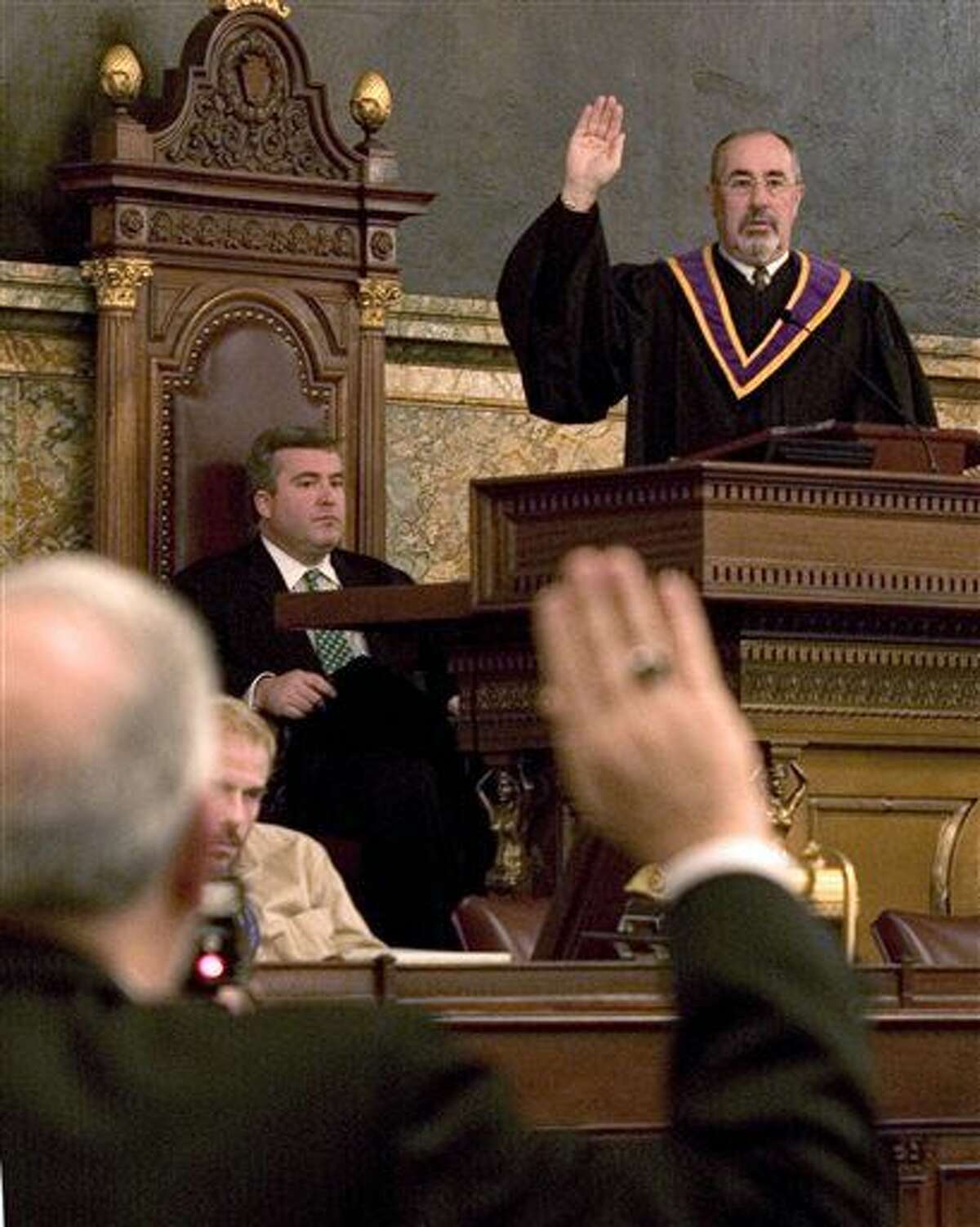 FILE - In this Dec. 13, 2004, file photo, Pennsylvania Supreme Court Justice Michael Eakin recites the oath of office during the proceedings of the 55th Pennsylvania Electoral College at the State Capitol in Harrisburg, Pa. Eakin's decision to step down was announced Tuesday, March 15, 2016, in a widening scandal over the exchange of raunchy and offensive emails among friends and lawyers. (AP Photo/Daniel Shanken, File)