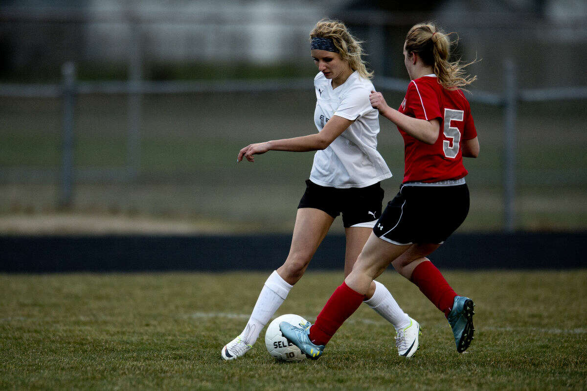 Bullock Creek's Brooklynn Gasser, left, dribbles the ball past Frankenmuth's Anna Barger in the second half of Wednesday's game. Frankenmuth defeated Bullock Creek 2-1.
