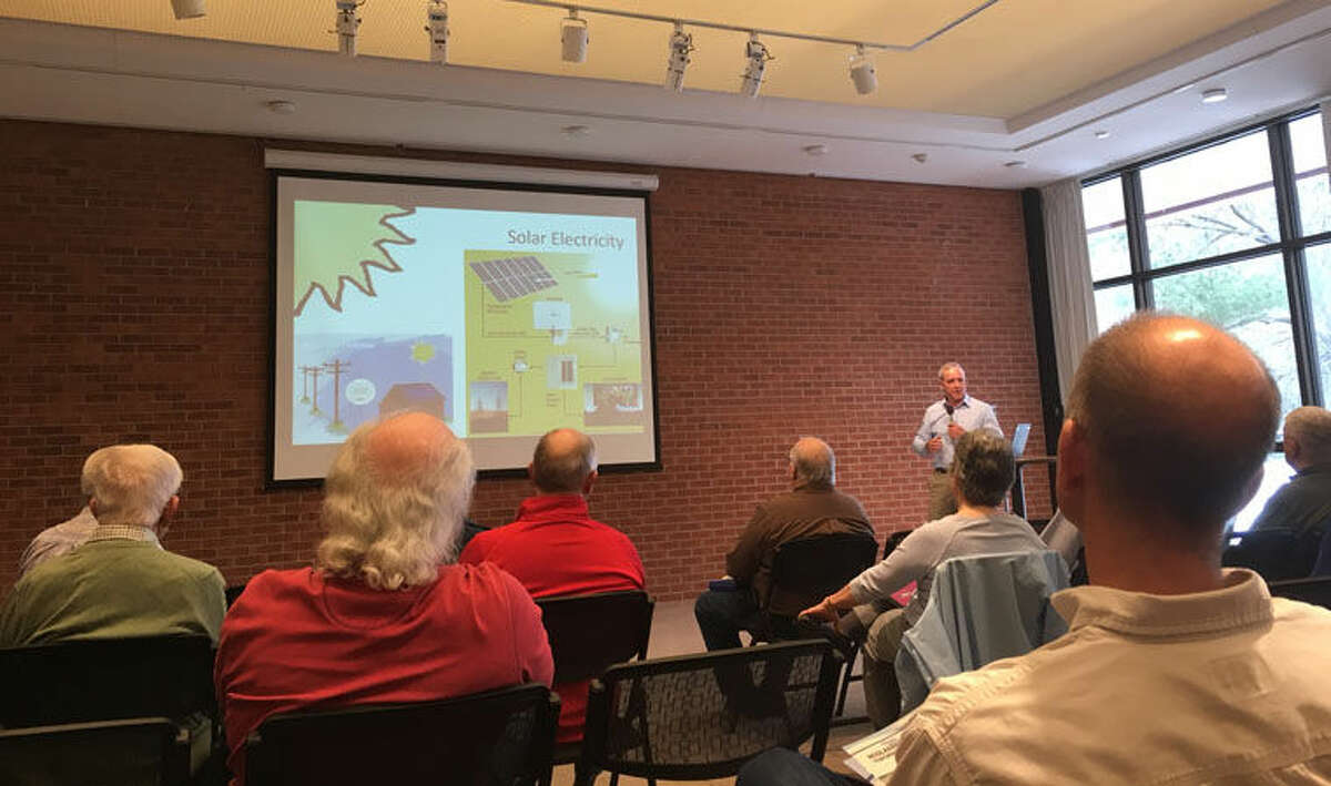 Steve Ellebracht, president of Midland Solar Applications, talks to residents about the benefits of solar energy and recent changes in technology during a recent Solarize Michigan workshop at the Midland Center for the Arts.