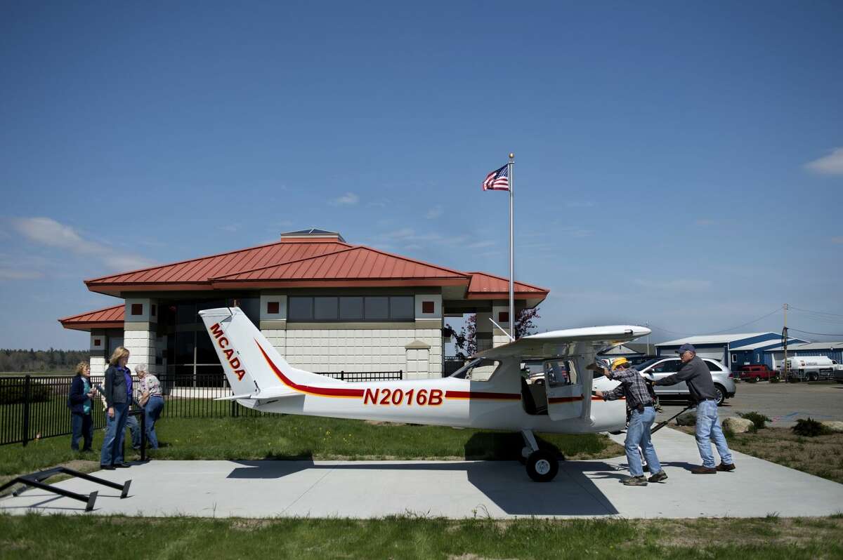 Doug Mason and Matt Jansen, right, move a life-size model airplane to its place at the Midland Community Aviation Discovery Area at Barstow Airport on Wednesday. The airplane was donated by the Experimental Aircraft Association. The discovery area will have a grand opening on June 5 from 2-4 p.m.