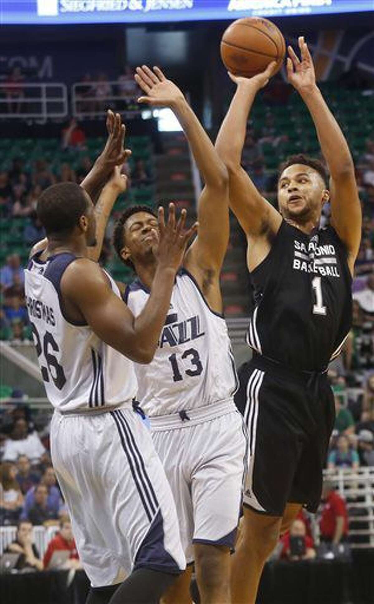 San Antonio Spurs' Kyle Anderson (1) shoots as Utah Jazz's Tyrone Wallace (13) and Dionte Christmas (26) defend during the first half of an NBA Summer League basketball game Monday, July 4, 2016, in Salt Lake City. (AP Photo/Kim Raff)