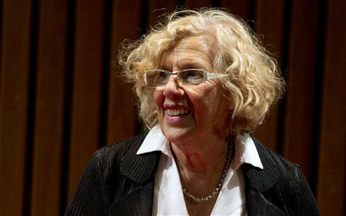 FILE - In this Friday, Aug. 28, 2015 file photo, Madrid's mayor Manuela Carmena arrives to present her new book "Por que las cosas pueden ser diferentes" or "Why things can be different," in Buenos Aires, Argentina. Madrid Mayor Manuela Carmena is warning dog owners they’ll face stiff fines or end up working weekends as street cleaners if caught in an upcoming dog poop crackdown. Carmena said Monday, April 18, 2016 that police would initially focus on two city districts where many dog owners simply let their pooches go without cleaning up after them. (AP Photo/Natacha Pisarenko, file)