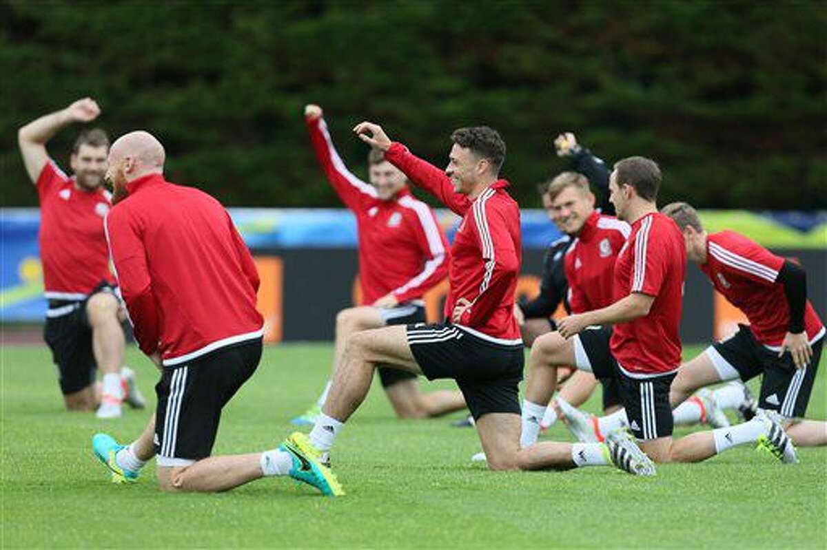 Wales' James Chester, center, stretches during a training session in Dinard, western France, Tuesday, July 5, 2016. Wales will face Portugal in a Euro 2016 semifinal match at the Grand Stade in Decines-Charpieu, near Lyon, France, Wednesday, July 6, 2016. (AP Photo/David Vincent)
