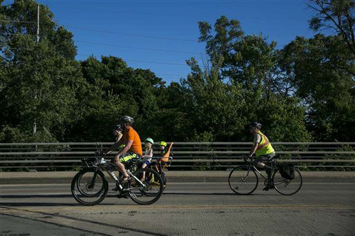 People participate in a silent bike ride in Kalamazoo Wednesday supporting the cyclists who were killed and injured in a crash the day before. 