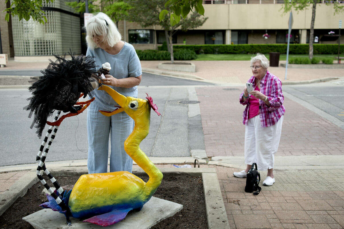 Alice Strack, right, watches as Sally Allan, left, puts the finishing touches on their sculpture "Prickly Pair." "This is our joint adventure in mischief," Strack said. Nine different sculptures are a part of the this year's summer sculpture series, "Whimsy."