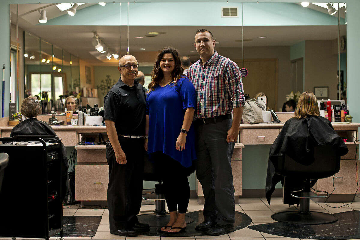 ERIN KIRKLAND | ekirkland@mdn.net From left, former owner Nathan Torres and current owners Krystal and Jeff Zienert pose for a photo on Wednesday at Nathan's Hair Unlimited. The salon celebrated its 40th anniversary.
