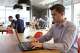 Frank Bertele, CEO of tech startup NETZ, works on his laptop in London Wednesday June 29, 2016. Within 24 hours of Britain’s vote to leave the European Union, London-based technology startup Netz saw five investors suspend hundreds of thousands of pounds in promised money. (AP Photo/Leonora Beck)