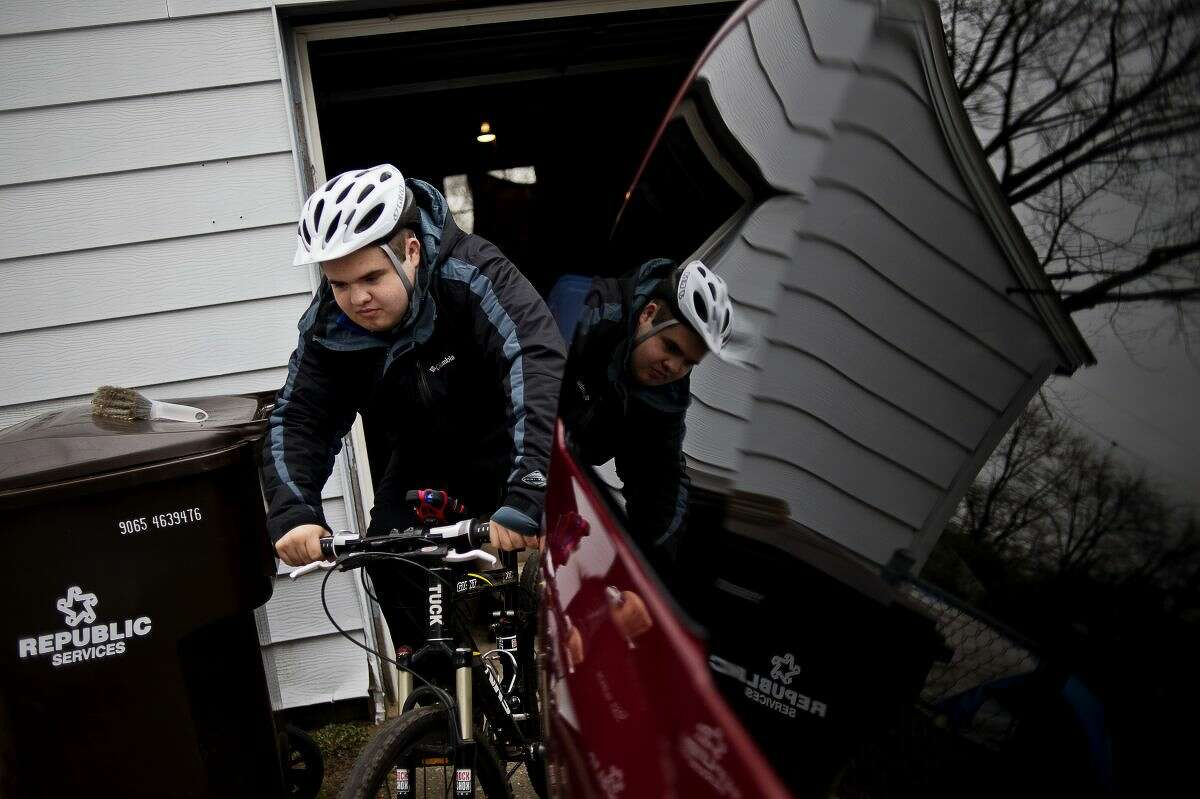 Tucker Mashue, 17, gets ready to go on a bike ride on Friday in Midland.