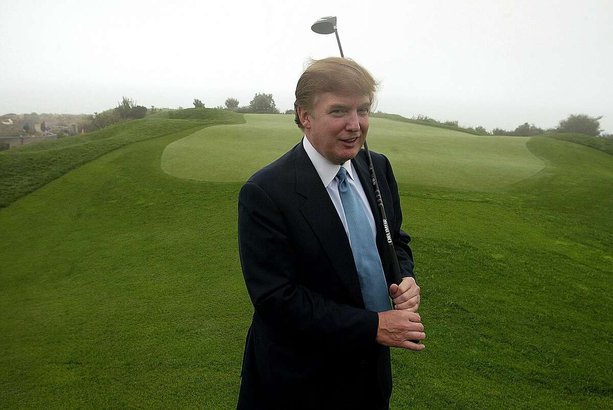 ADVANCE FOR WEDNESDAY, JULY 13, 2016, AT 12:01 A.M. EDT AND THEREAFTER - FILE - In this Nov. 9, 2002, file photo, Donald Trump holds a driver on the 11th green of his Ocean Trails Golf Club in Rancho Palos Verdes. (AP Photo/Damian Dovarganes, File)