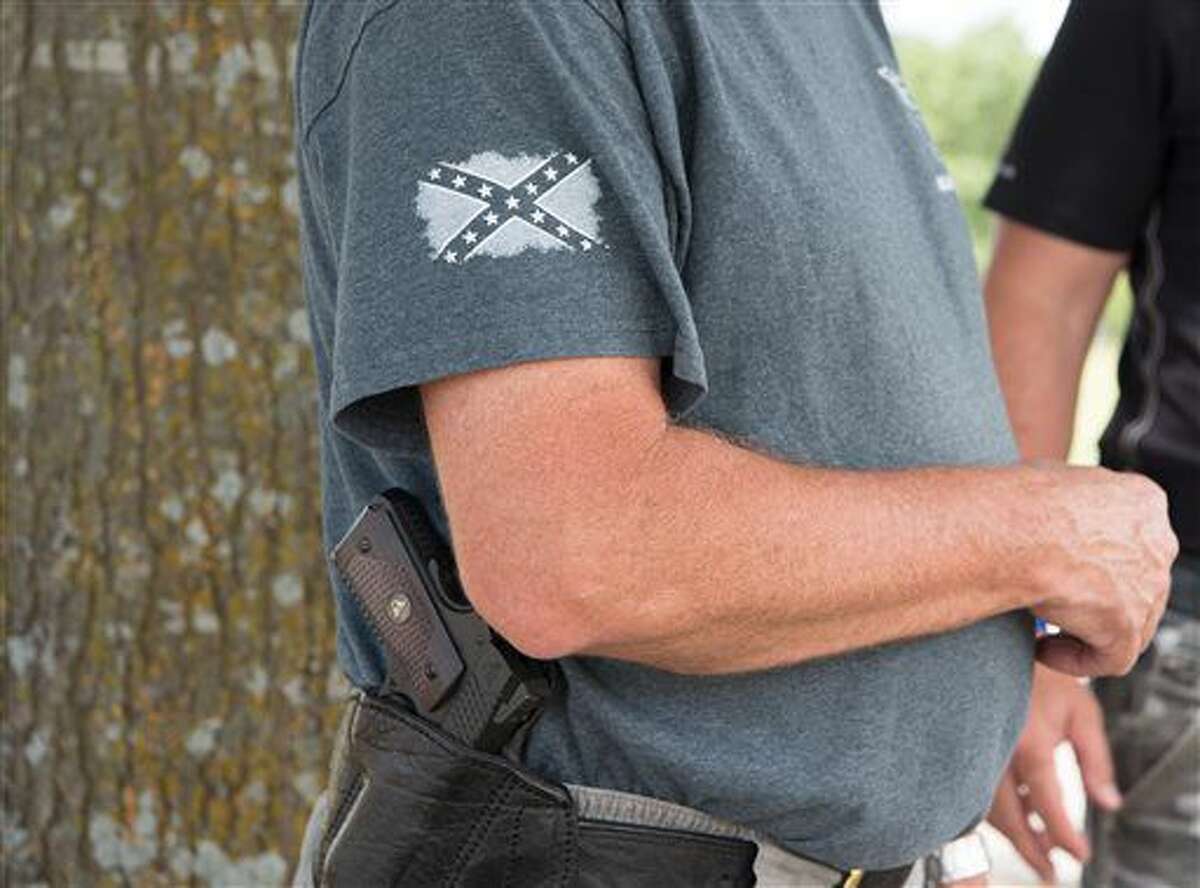 Bill Wilson, owner of Wilson Combat, a firearms manufacturer based in Berryville, Arkansas, openly carries a firearm on Saturday, July 9, 2016 in Paris, Texas. Wilson said he's concerned that any restrictions _ whether it’s how or where a firearm can be carried or the type of firearm that can be bought _ is a slippery slope to restricting his Second Amendment rights. (AP Photo/Lisa Marie Pane)