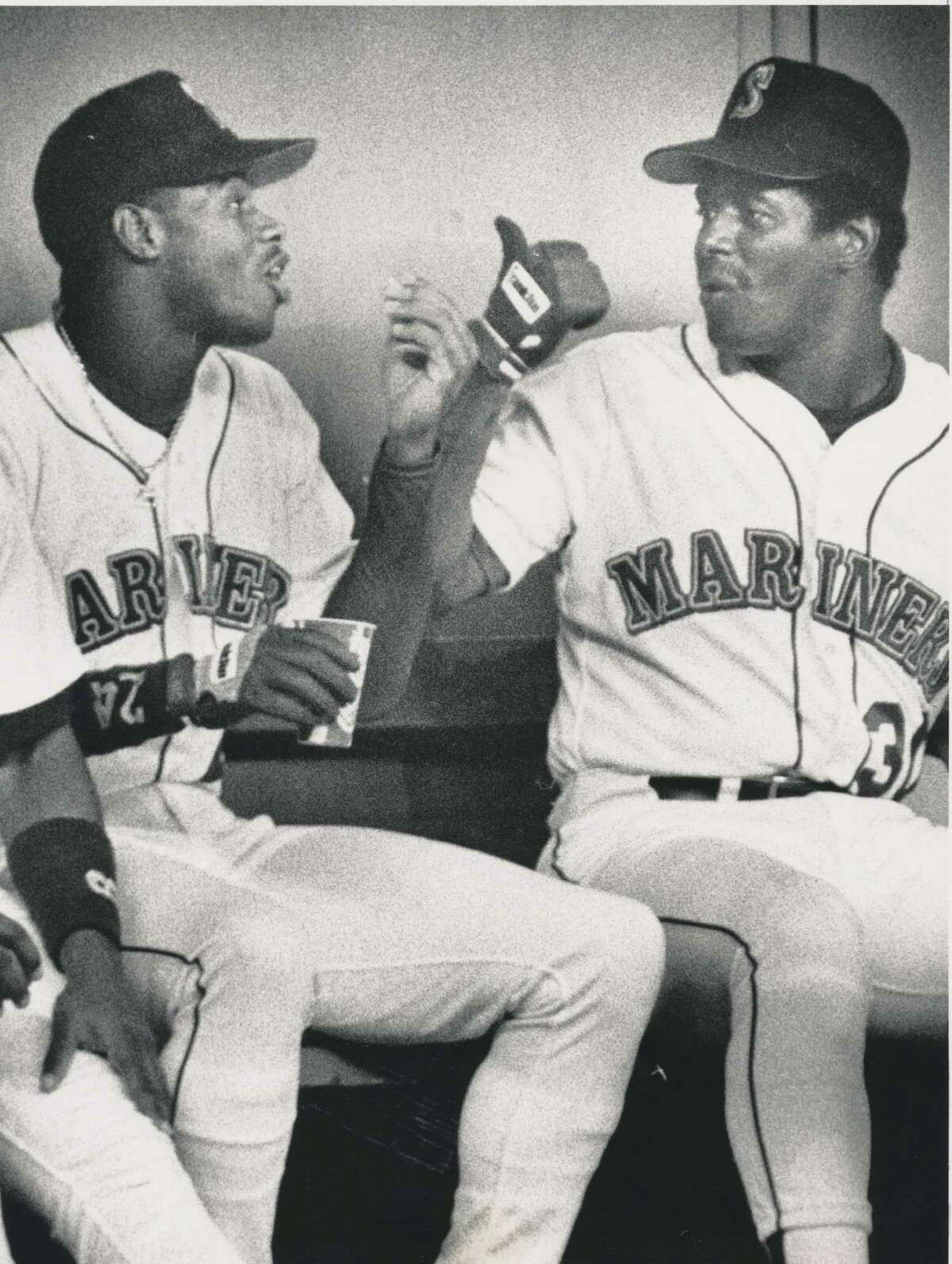Original caption dated August 31, 1990: "Ken Griffey Sr. talking to son Ken Jr. after a play in the outfield where he almost made a sliding catch." Seattle P-I Collection image number 2000.107.079.19.06