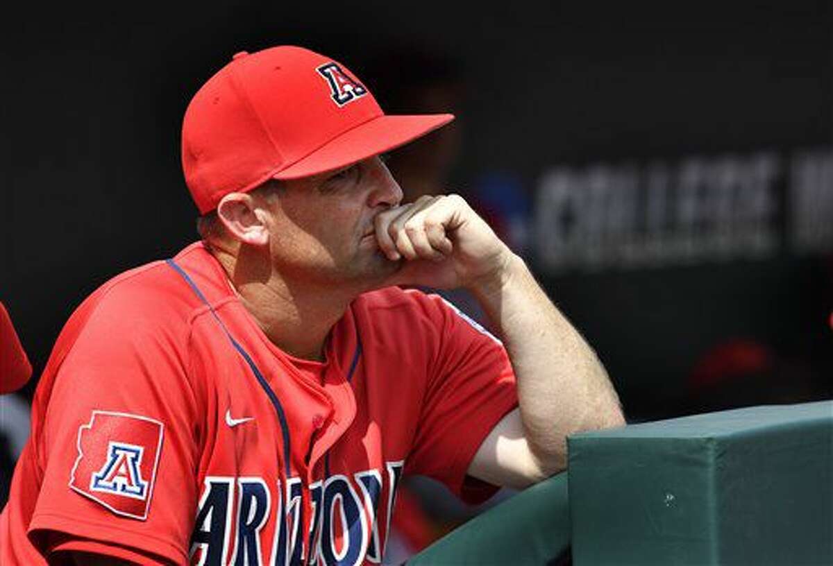 Arizona pitcher Bobby Dalbec, third from right, is congratulated at the  dugout against Coastal Carolina in the fifth inning in Game 3 of the NCAA  College World Series baseball finals in Omaha