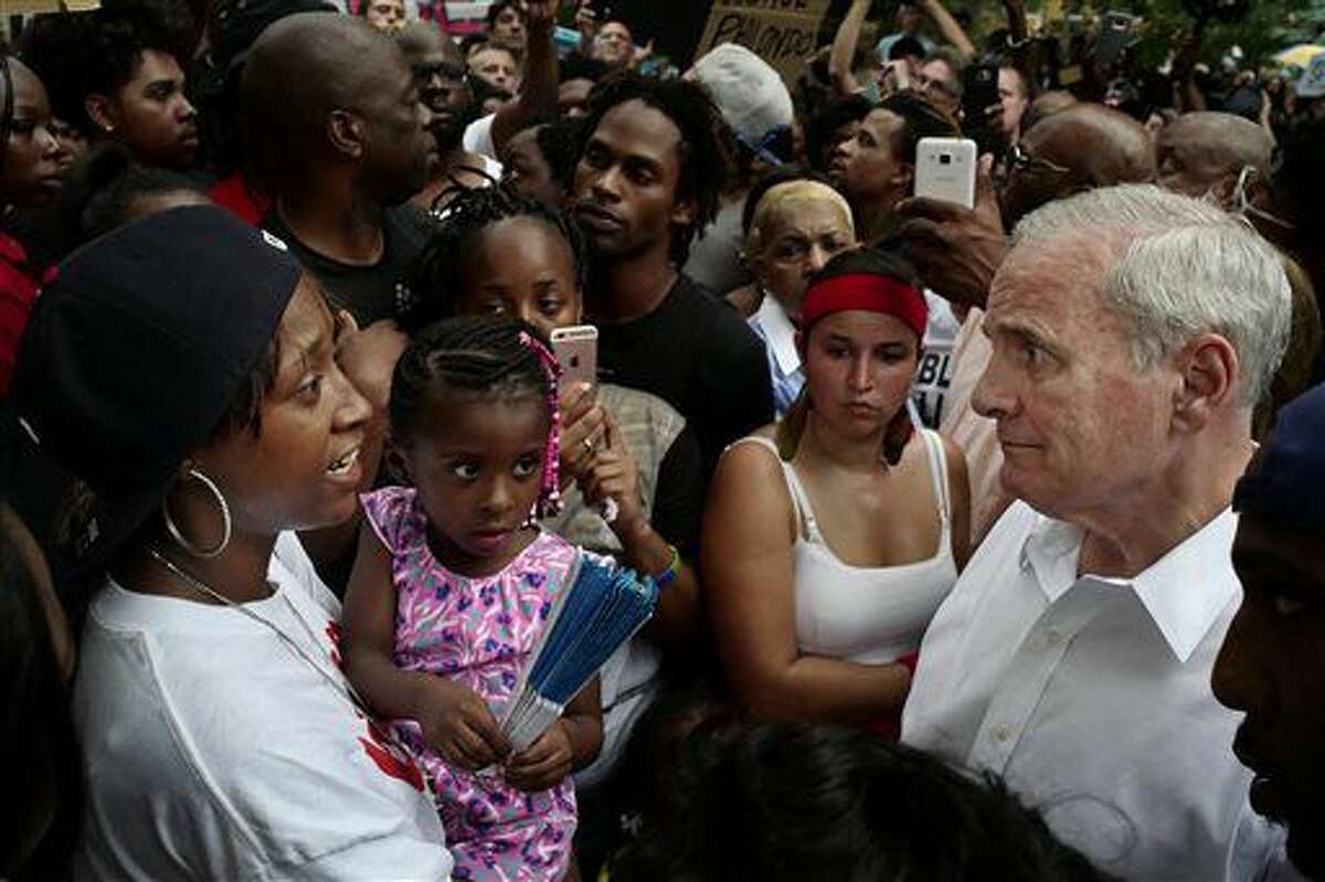 Minnesota Gov. Mark Dayton, right, meets with people, including Diamond Reynolds, left, and her daughter, at the Governor's Mansion as protesters gathered to decry the shooting death of Reynolds' boyfriend, Philando Castile, by police in Falcon Heights, Minn. (Richard Tsong/Star Tribune via AP)