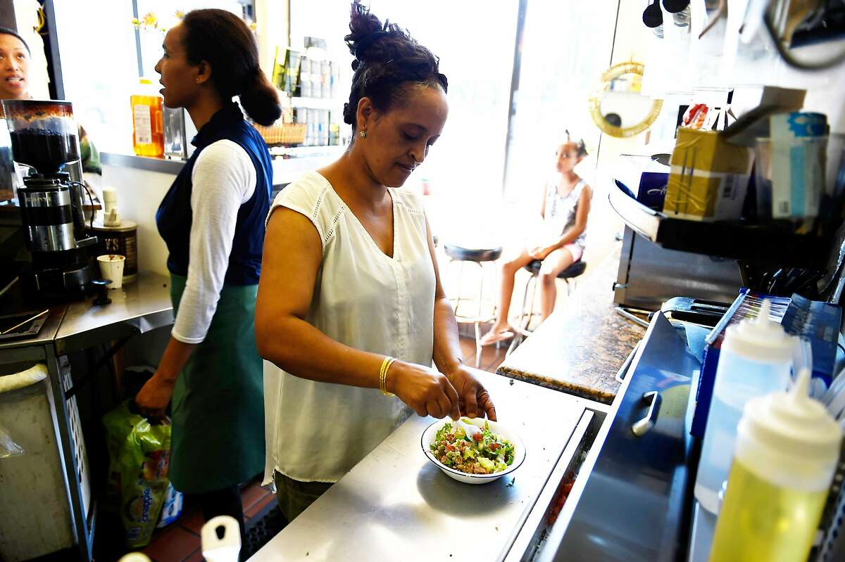Nigisty Eyasu prepares a tuna salad dish on Tuesday, July 12, 2016 at Alem's Coffee in Oakland, California.
