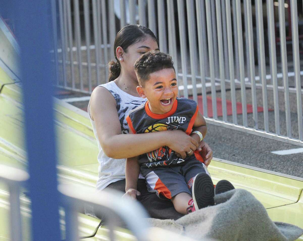 Sandra Acosta of Greenwich provides the lap for her son, Azariah Acosta, 4, reacting, as the pair rode the big slide during the annual St. Catherine of Siena Church Carnival of Fun at the church in the Riverside section of Greenwich, Conn., Wednesday, July 13, 2016. The remaining nights for the Carnival of Fun are Thursday - Saturday, 6 p.m. - 11 p.m., at the church located at 4 Riverside Avenue in Greenwich. First prize in the Carnival of Fun raffle ($25 per ticket) is a red metallic 2016 BMW 228i.