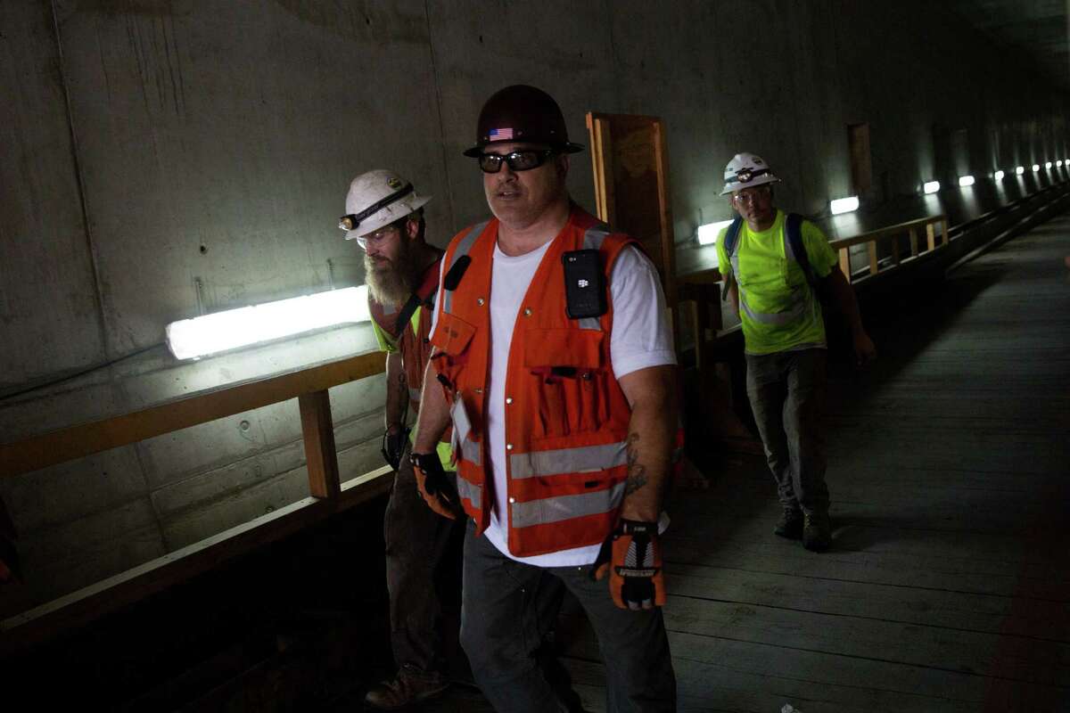Construction workers leave the tunnel from the south entrance.
