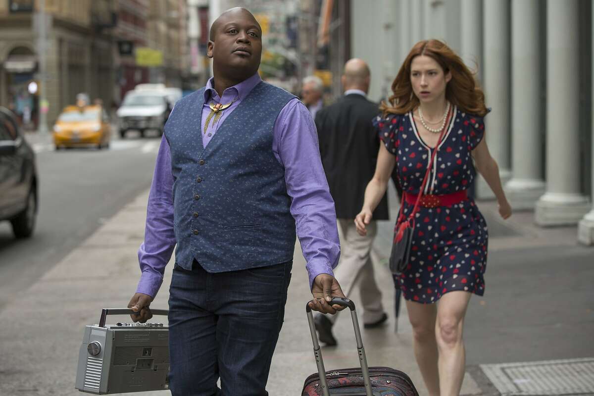 In this image released by Netflix, Tituss Burgess, left, and Ellie Kemper appear in a scene from "Unbreakable Kimmy Schmidt." On Thursday, July 14, 2016, Burgess was nominated for outstanding supporting actor in a comedy for his role in the series.Kemper also received a nomination for outstanding actress and their show was nominated for outstanding comedy. The 68th Primetime Emmy Awards will be broadcast live on ABC beginning at 8 p.m. ET on ABC. (Eric Liebowitz/Netflix via AP)
