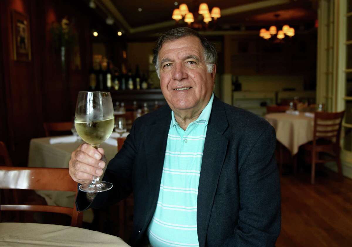Greenwich Wine Society Director Dean Gamanos holds a glass of Pino Grigio, one of his favorite types of wine, at The Ginger Man in Greenwich, Conn. Thursday, July 14, 2016. The Greenwich Wine Society was founded in 2008 and meets up frequently for wine tastings, dinners and bus trips to local vineyards. The club is an informal meetup for wine enthusiants to meet, network and make new friends.