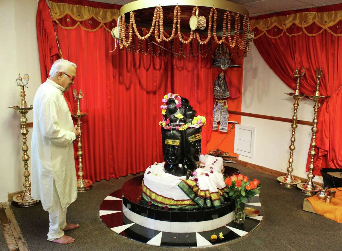 Janardan Upadhyaya, 79, of Fairfield, prays in front of Shiva, the god of destruction on Tuesday, July 12.