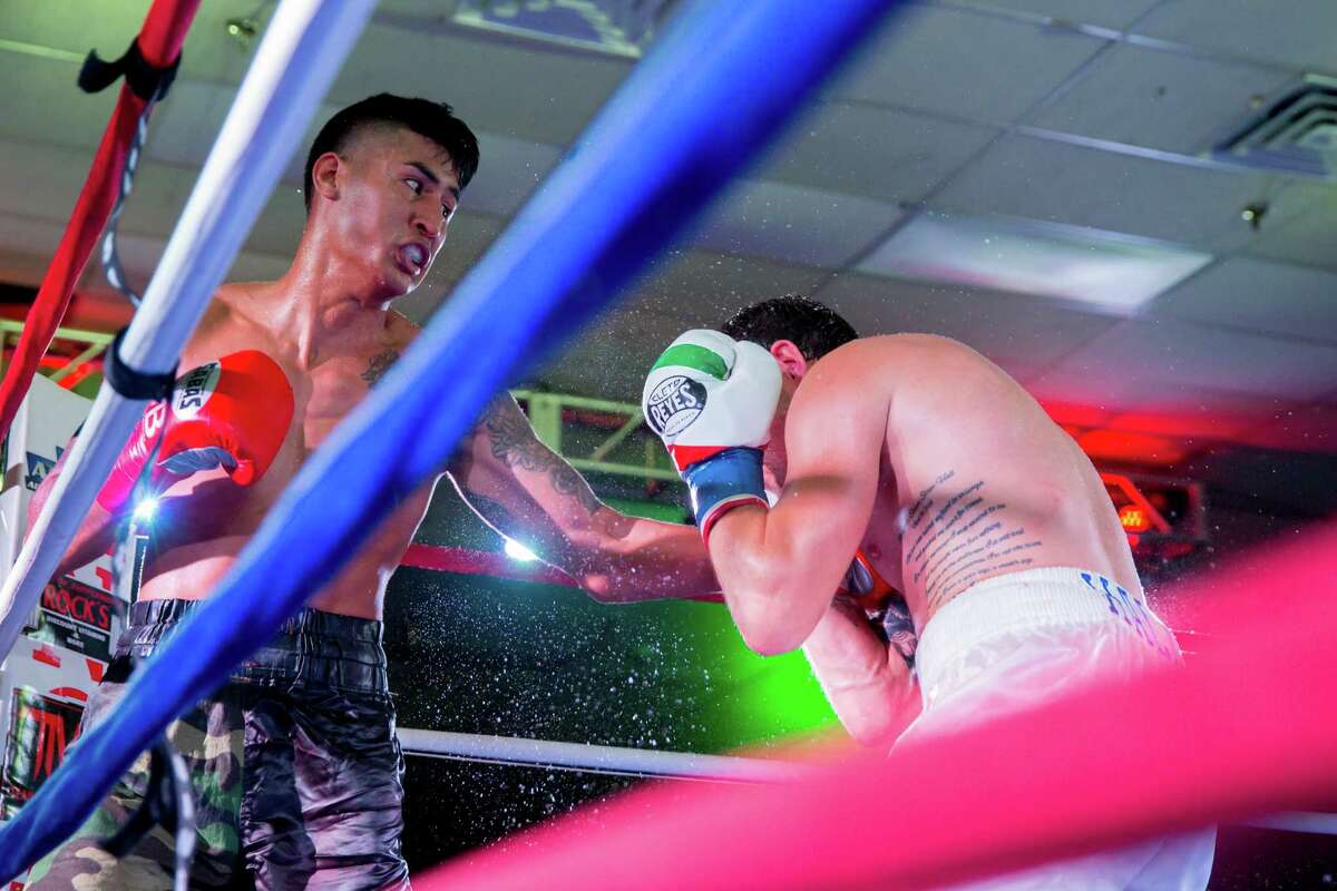 Steven Hall (right) takes a punch from Armando Cardenas during their pro boxing match on Aug. 8, 2015, at the San Antonio Event Center.
