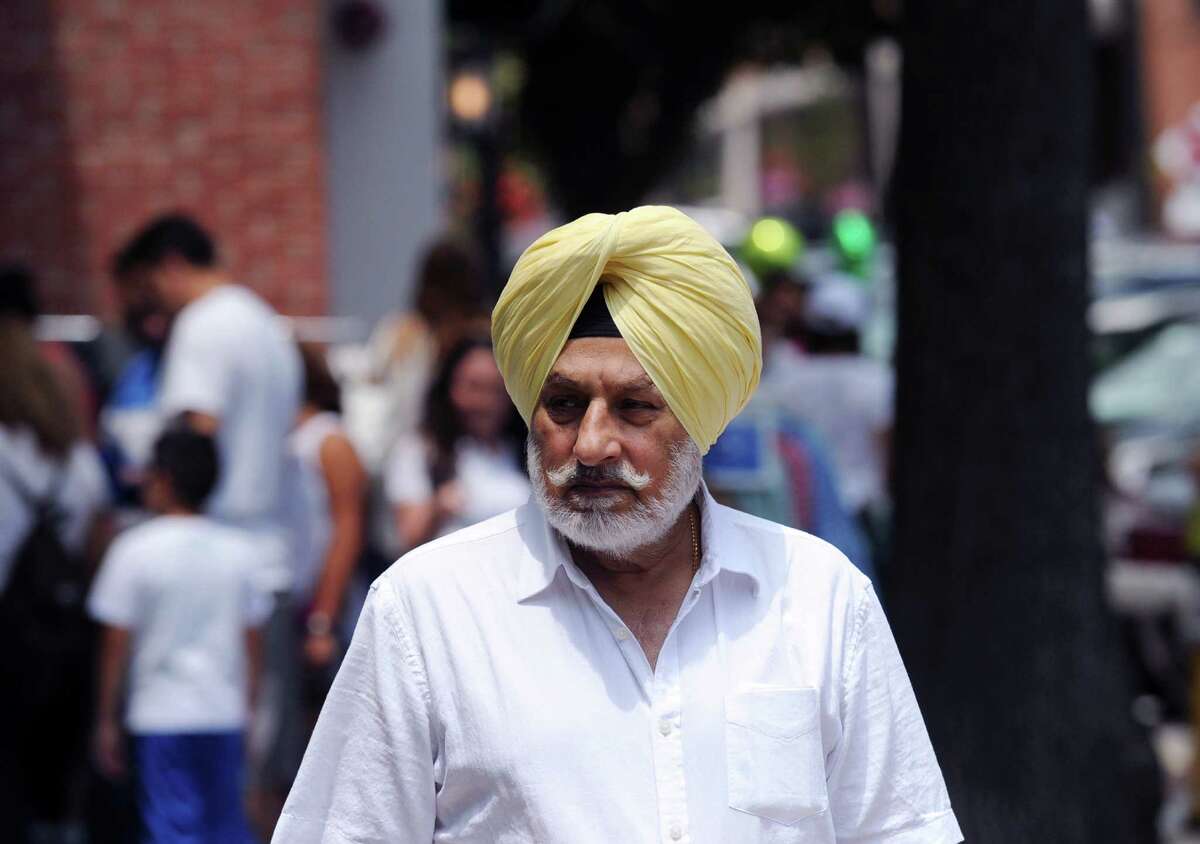 Ravinder Gill of Paramus, N.J., in town visiting family, shops during the annual Sidewalk Sales organized by the Greenwich Chamber of Commerce on Greenwich Avenue, Greenwich, Conn., Thursday, July 14, 2016. According to the Greenwich Chamber of Commerce website, over 120 businesses are participating in the central Greenwich sales event that features merchants offering deep discounts on brand items under small tents placed outside their stores. The event runs from 10 a.m. to 6 p.m. on Friday and Saturday, and from 11 a.m. to 5 p.m. on Sunday, the final day of the sales.