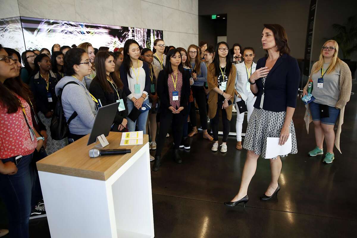 Joan Scott (right), director of community relations at Dolby Laboratories, welcomes high schoolers to a Girls Who Code event at the Dolby Laboratories headquarters in San Francisco, California, on Thursday, July 14, 2016.