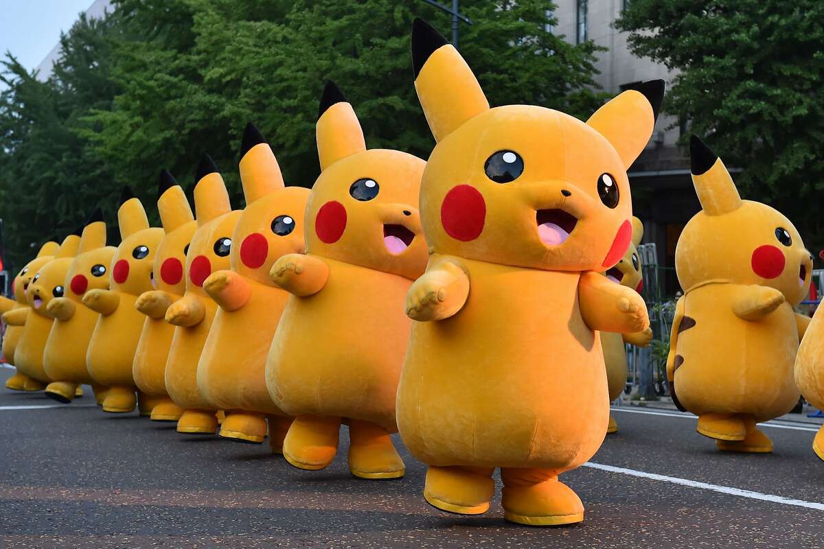 (FILES) This file picture taken on August 2, 2015 shows costumed performers dressed as Pikachu, the popular animation Pokemon series character, attending a promotional event at the Yokohama Dance Parade in Yokohama. / AFP PHOTO / KAZUHIRO NOGI / FOCUS by Harumi OZAWA KAZUHIRO NOGI/AFP/Getty Images