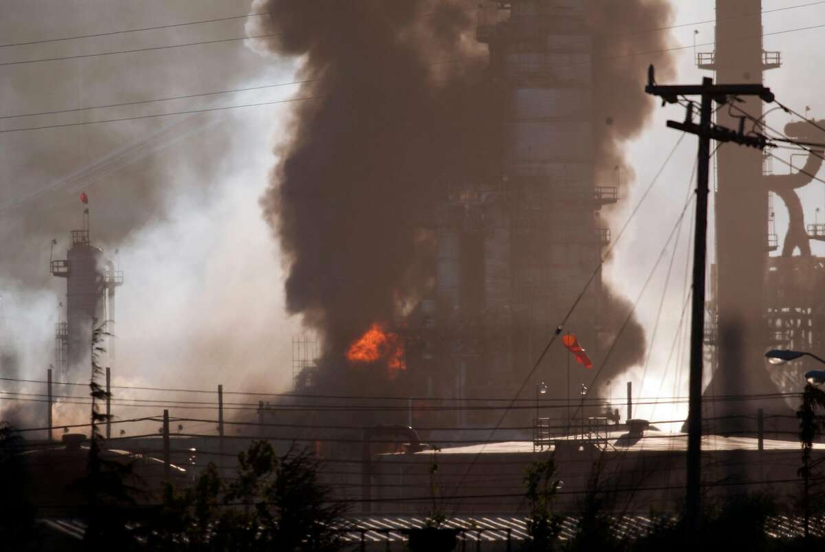 Smoke and flame billow from a crude oil unit at the Chevron refinery in Richmond, Calif., Monday, Aug. 6, 2012. The facility makes high-quality products that include gasoline, jet fuel, diesel fuel and lubricants, as well as chemicals used to manufacture many other useful products. (AP Photo/ContraCosta Times, D. Ross Cameron )