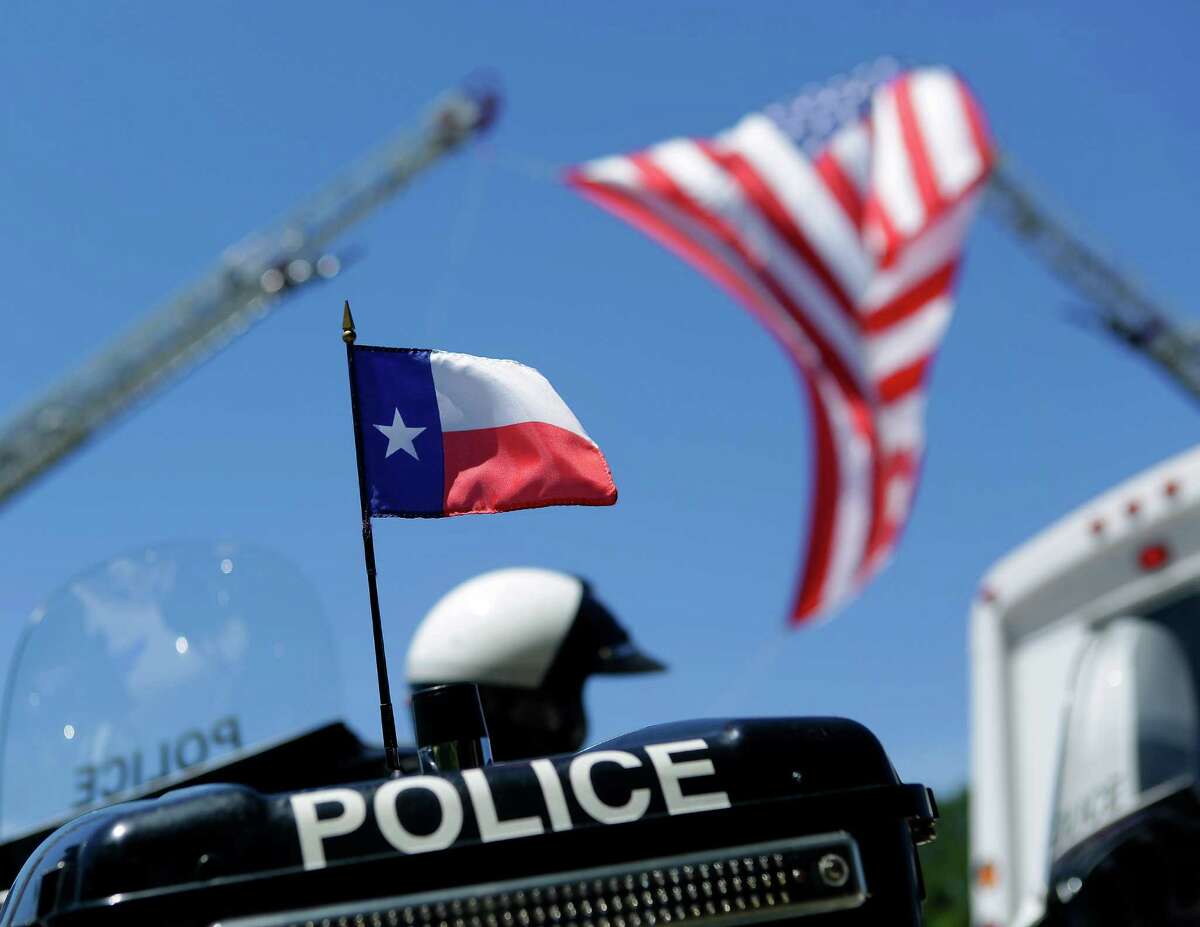 A Texas flag is on the back of a police motorcycle outside of the funeral for Dallas police Sergeant Michael Smith at Watermark Community Church, Thursday, July 14, 2016, in Dallas.