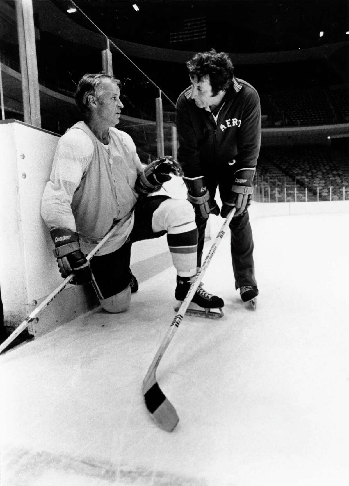 ﻿Gordie Howe, nicknamed "Mr. Hockey," and coach Bill Dineen talk ﻿at practice at The Summit in 1976.