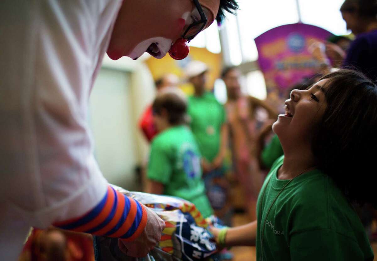 Taylor Albin boss clown at Ringling Bros. and Barnum & Bailey shares a moment with Mia while he was presenting her with gifts at MD Anderson Children?•s Cancer Hospital, Thursday, July 14, 2016, in Houston.
