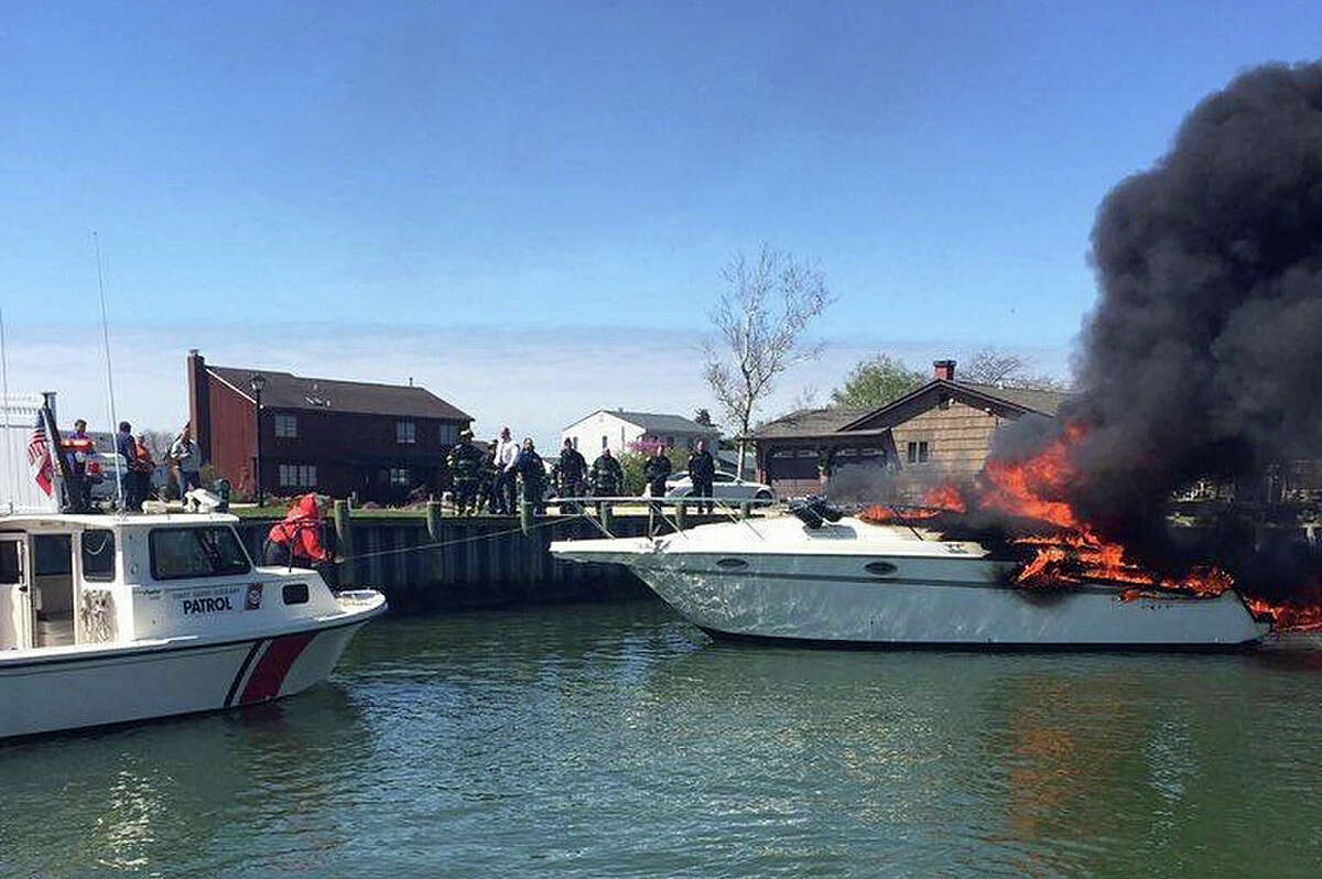 A Coast Guard Auxiliary crewmember maintains positive control of a flame engulfed pleasure craft near Great Neck Creek in Copiague, New York, April 30, 2016. The Copiague Fire Department assisted the Coast Guard Auxiliary crew and extinguished the fire onboard the vessel. The U.S. Coast Guard reports that safety boardings in Long Island Sound have shown an increase in the number of boats operating without proper safety equipment. Coast Guard units have noted that the two most frequently forgotten safety items are also the most important: life jackets and fire extinguishers.