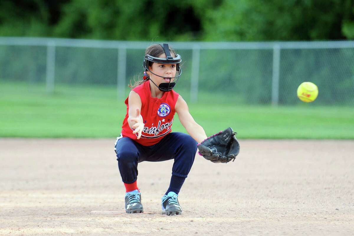 Eight-year old Abby D'Orta sticks her tongue out as she fields a ground ball during pratice at Troy Field on Tuesday, July 12, 2016. D'Orta's team, the girls Babe Ruth 8U Stars, will compete in the Babe Ruth Girls World Series in Florida next month.