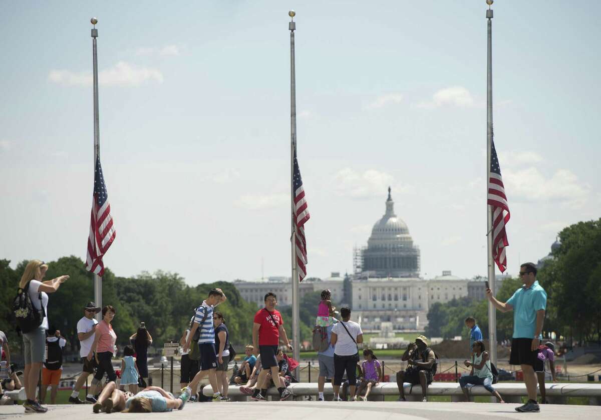 American flags fly at half-staff in honor of the victims of the police ambush in Dallas. A reader says it is wrong to assign blame for such horrific incidents to anyone but the perpetrators.
