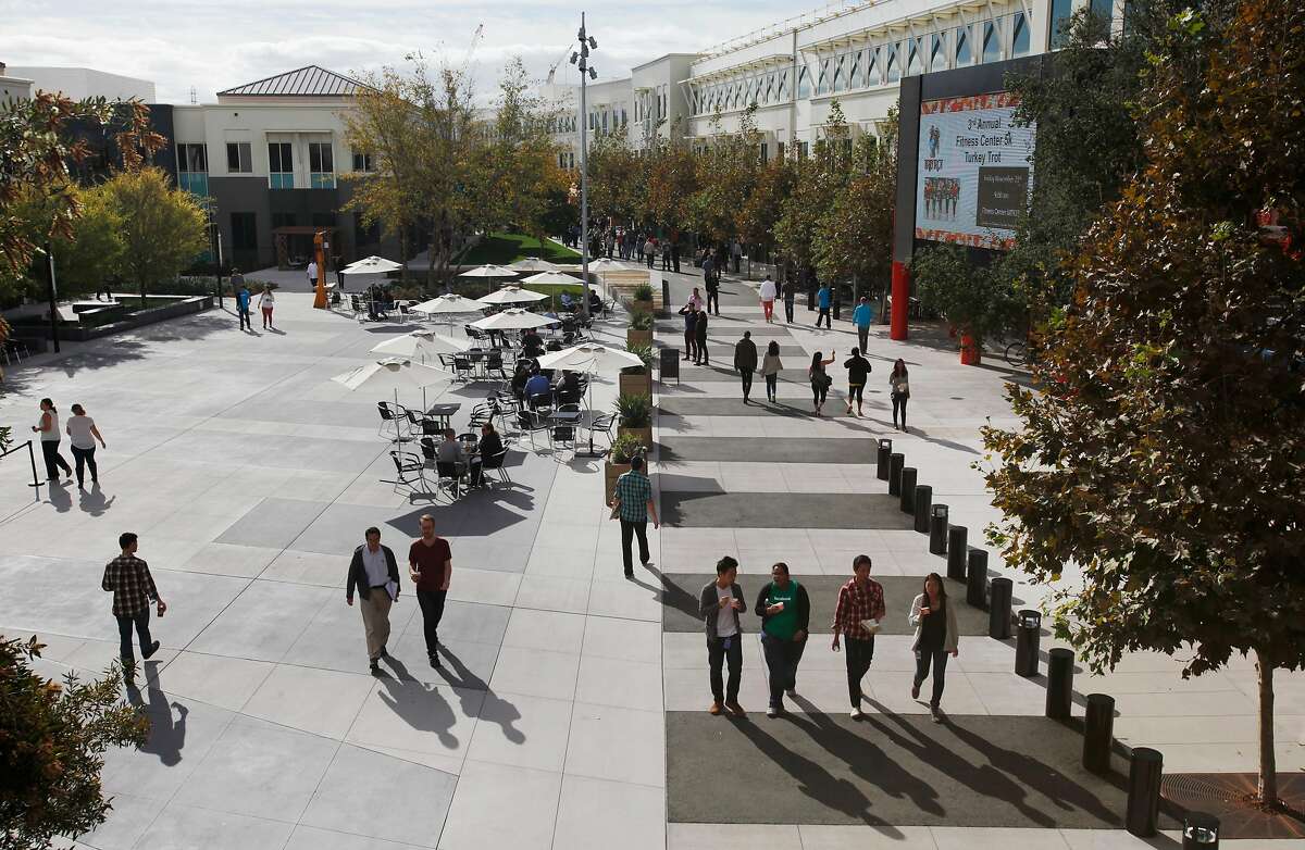 People walk around on the Facebook campus Nov. 12, 2014 in Menlo Park, Calif.